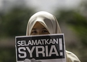 A protester holds a placard reading © FreedomHouse2/Flickr/Creative Commons
